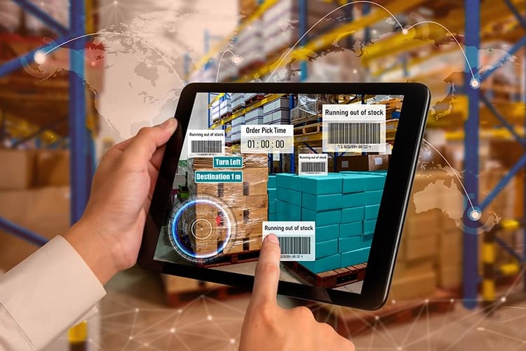 Person using tablet to monitor warehouse inventory and deliveries, representing logistics software development services for end-to-end 3PL process management.