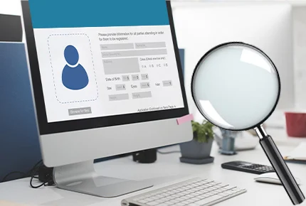 Computer screen displaying a digital form with a magnifying glass in front, symbolizing intelligent document processing solutions used to extract and verify data accurately.