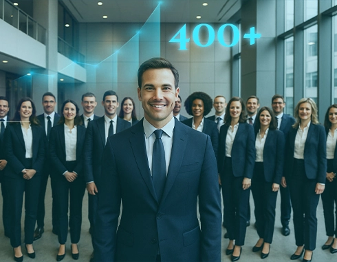 Business team standing confidently in a corporate office with a “400+” growth indicator, representing how integrated HR and payroll systems helped Softenger streamline recruitment, compliance, and workforce management.
