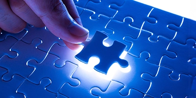 Completing a puzzle with a missing piece to symbolize customized business solutions