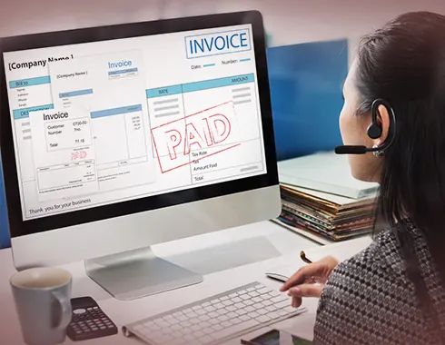Woman reviewing a digital invoice marked “PAID” on a computer screen, representing how Custom Retail Software automates supplier fee management, approvals, and complex retail workflows.